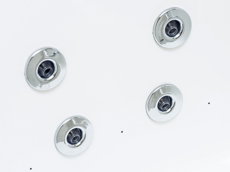 A silver metal sink faucet with four visible knobs against a white background.